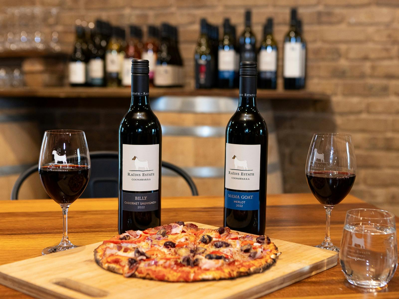 A table with pizza and wine