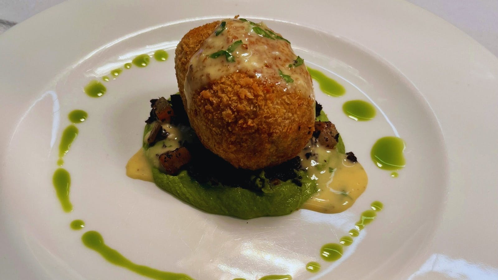 Crispy Pork Croquettes served on pea puree with