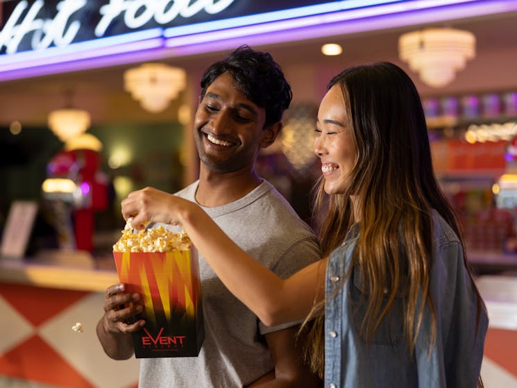 Couple enjoying popcorn at Skyline Drive In Blacktown