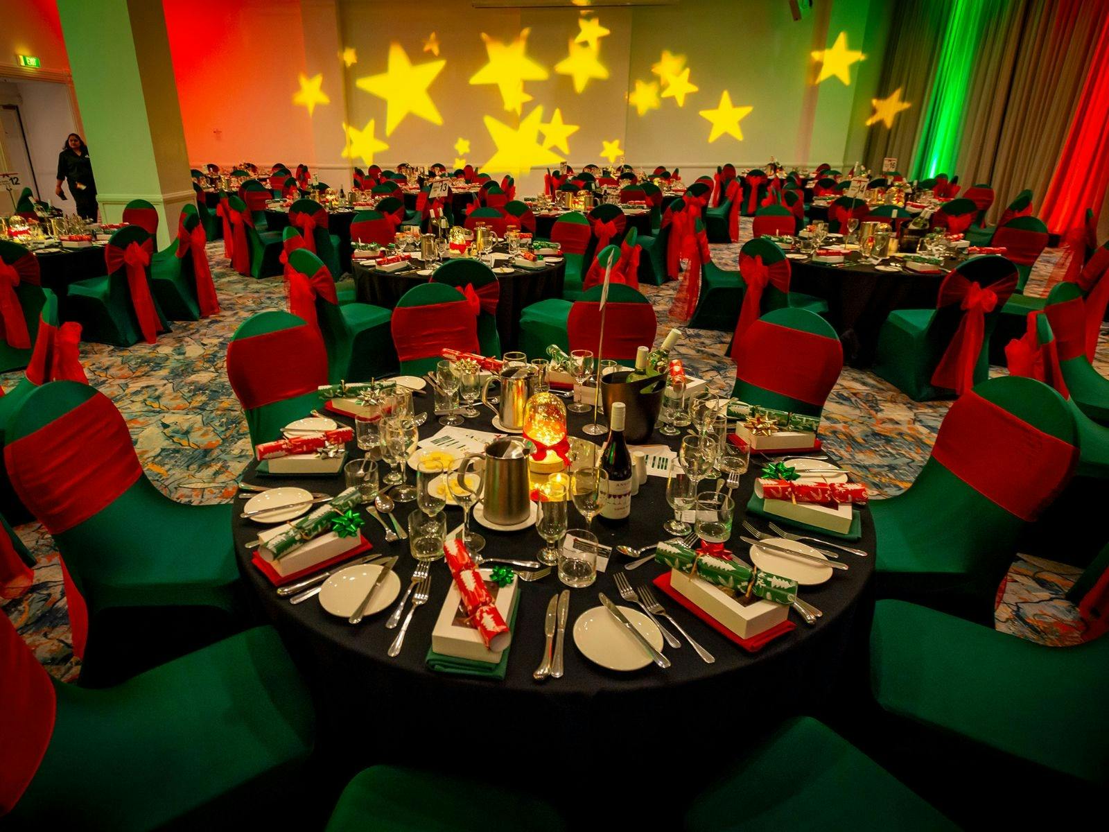 Function space room Christmas party setup with red and green light and tables