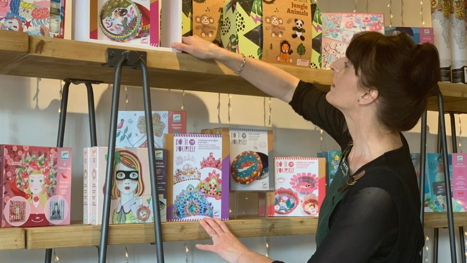 Owner Nicola rearranging the shelves