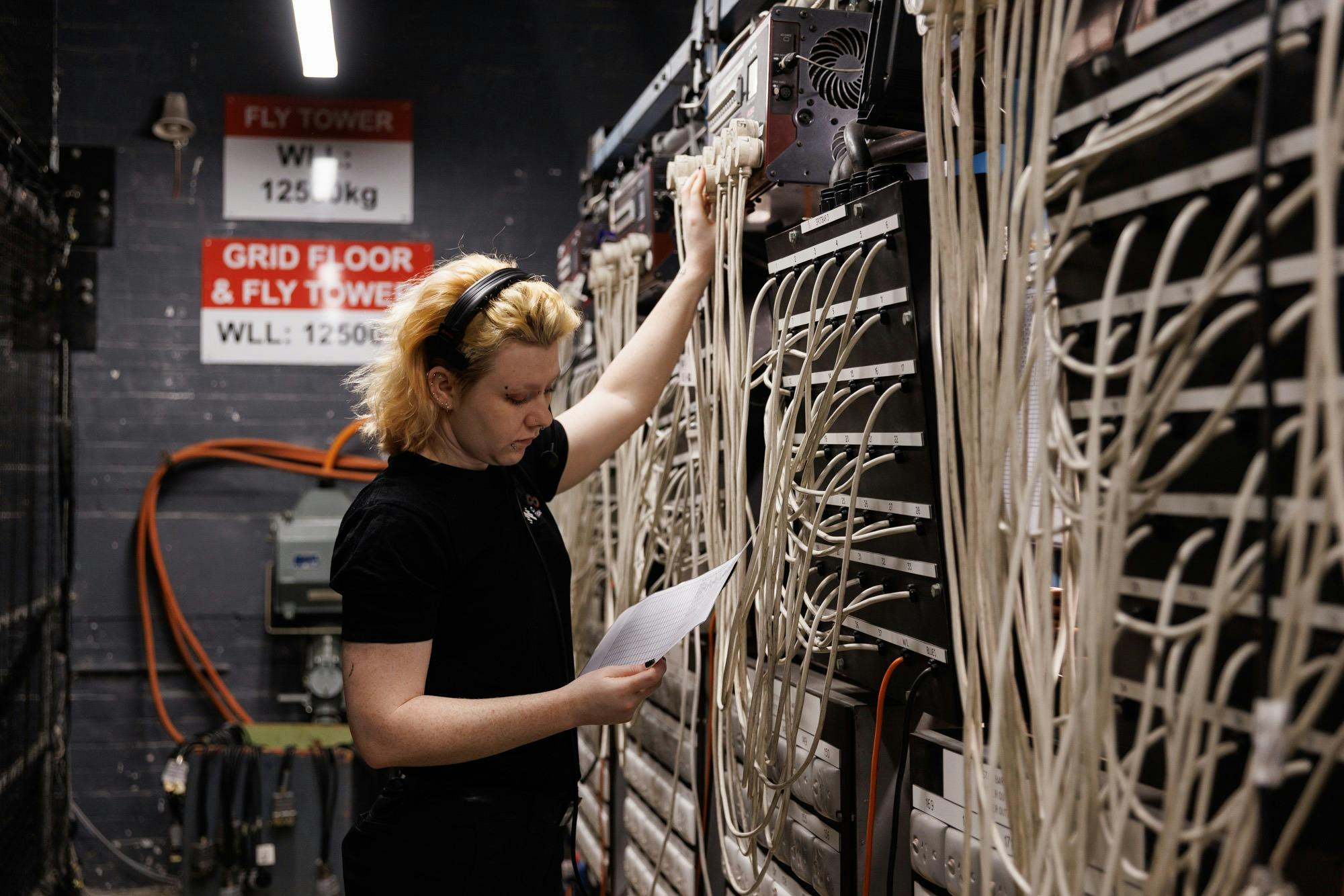 Backstage crew monitoring electricity system pre performance.
