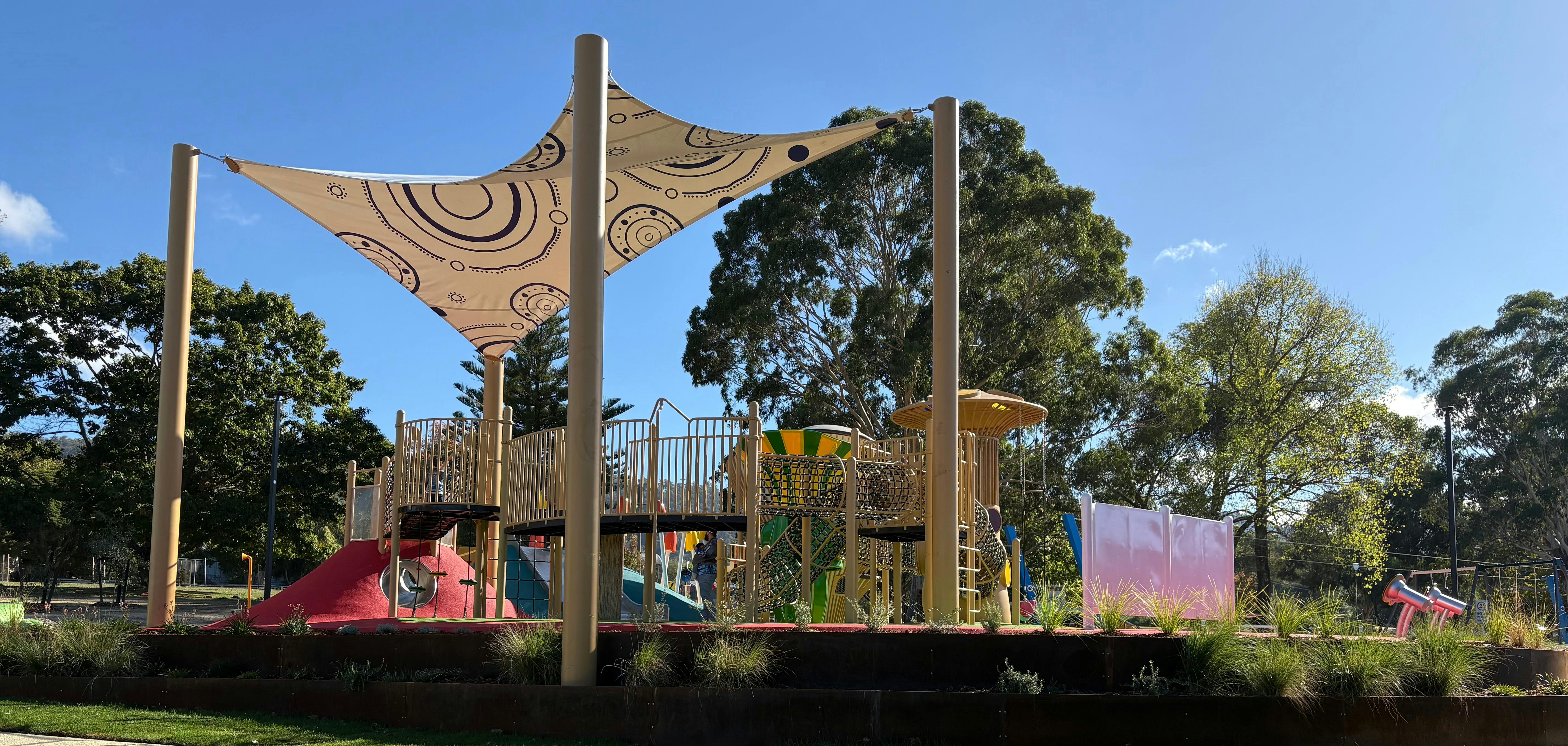 an elevated play structure with stairs and railings covered by a tarp