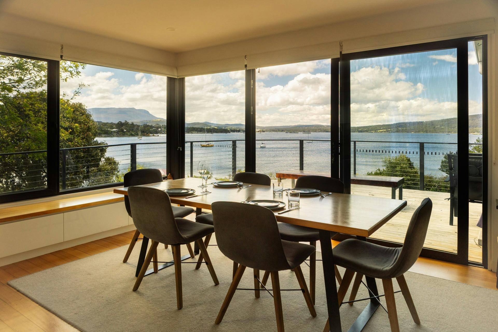 Sea and mountain view from dining room at Snug on the Bay showing the dining table