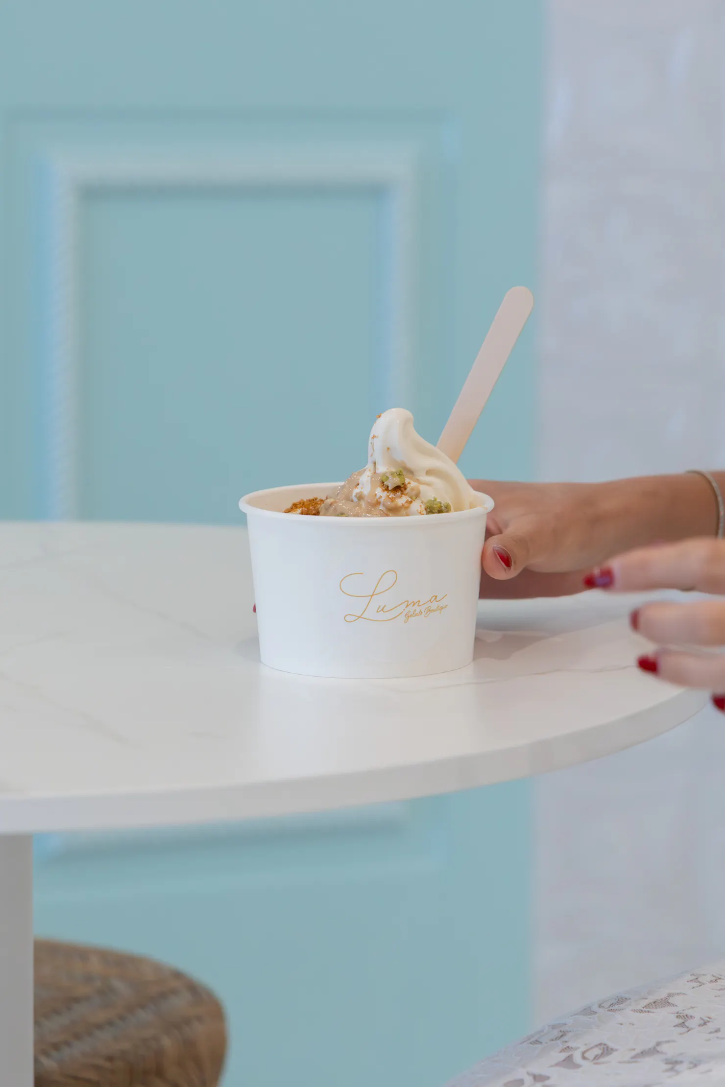 A cup of soft serve gelato with toppings at LUMA Gelato on a table