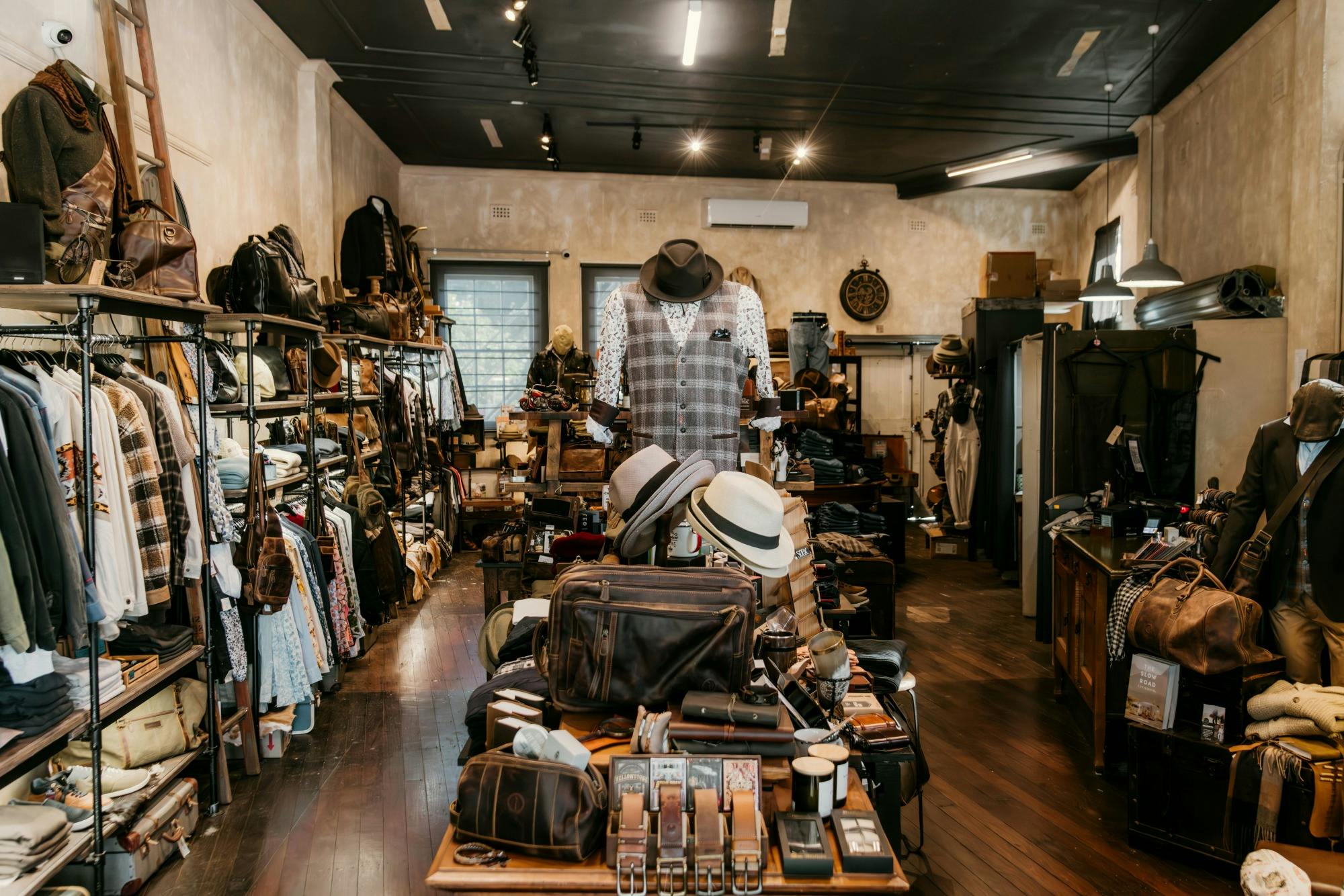 Inside Bolt + Buckle menswear store with shirts, leather bags, hats, belts and journals
