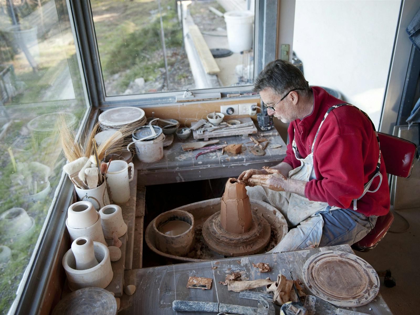 Ben at the wheel working on a vase