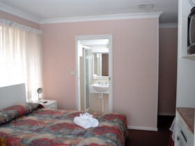 Queen size bed with view into ensuite