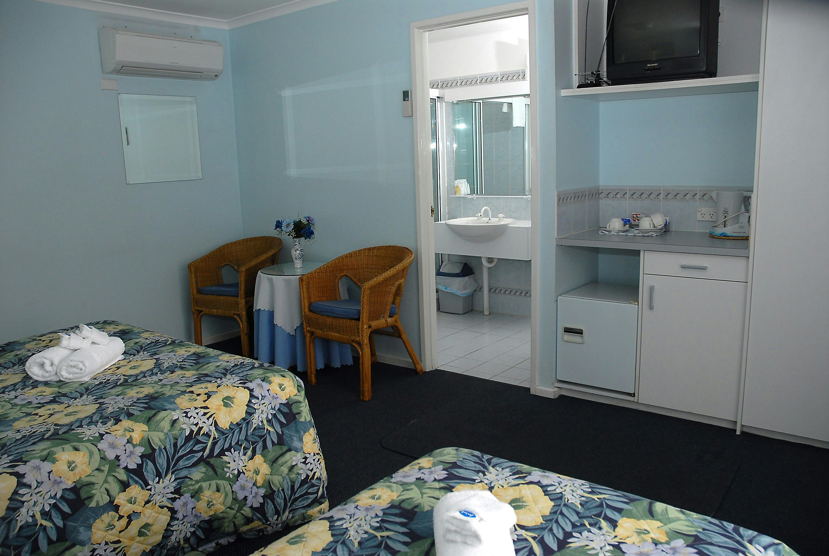 Queen and single bed looking at ensuite  area