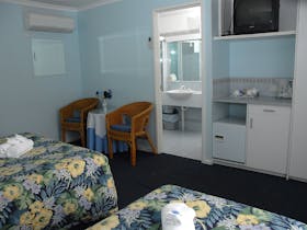Queen and single bed looking at ensuite  area