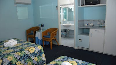 Queen and single bed looking at ensuite area