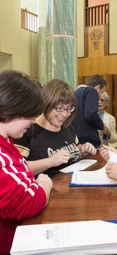 Image of a Visitor Services Officer assisting visitors to Parliament House