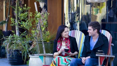 Couple drinking coffee outdoors