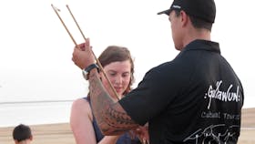Shannon from Sail Darwin teaching Louise how to throw a spear with a woomera