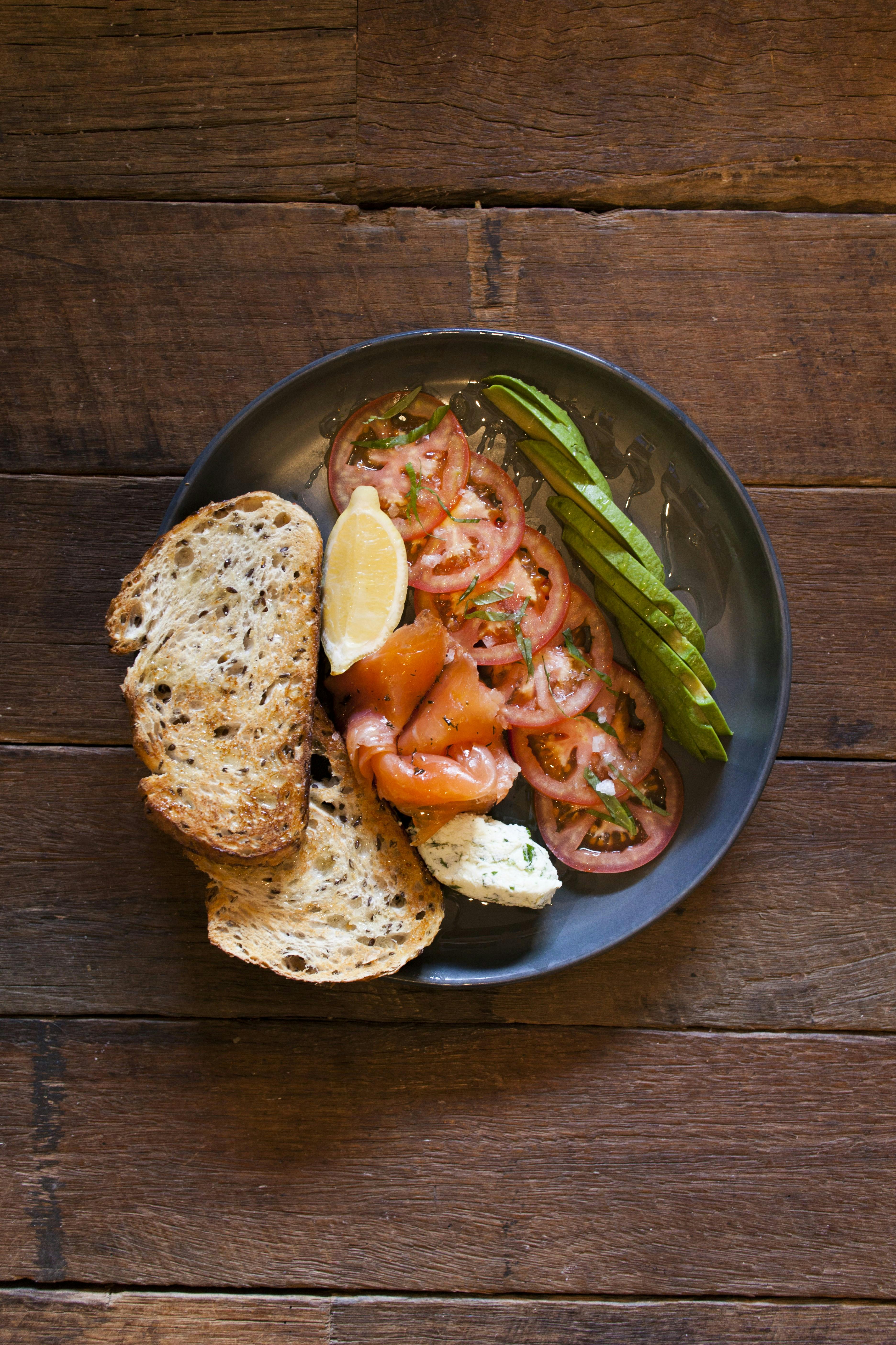 Plate of salmon, vegetables with toast