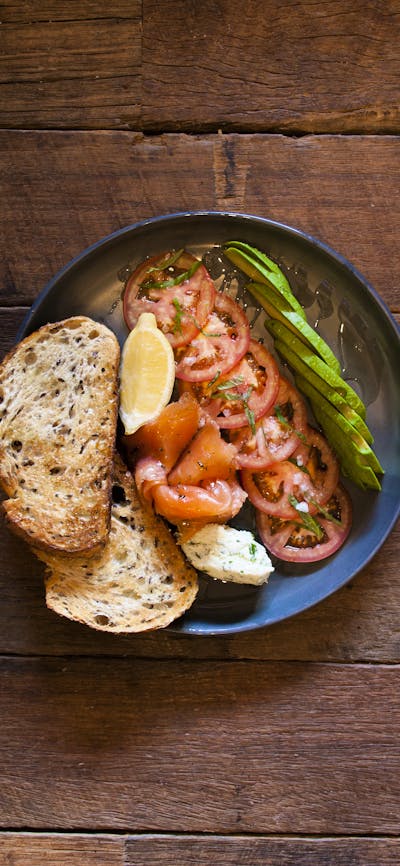 Plate of salmon, vegetables with toast