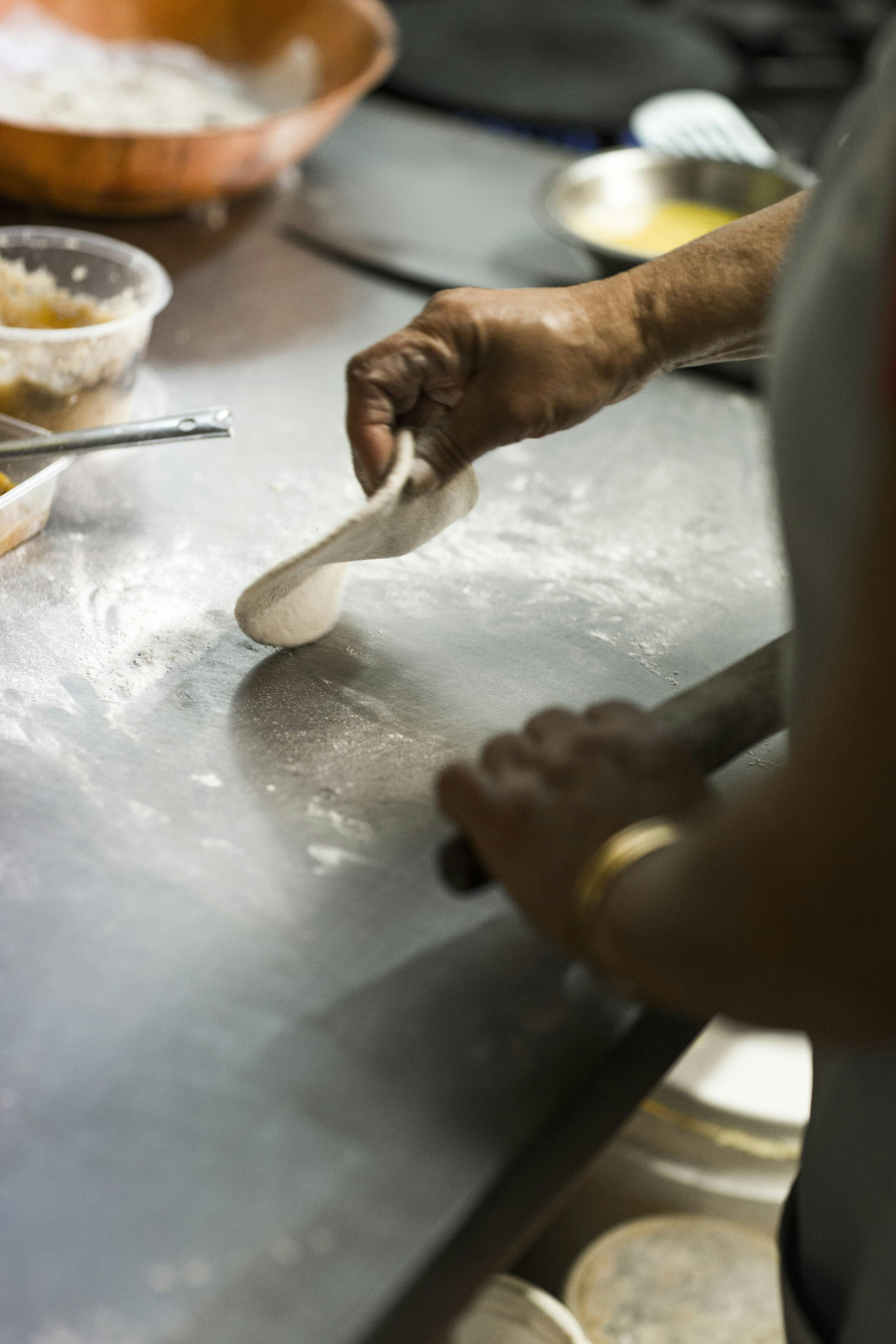 Chef rolling out dough