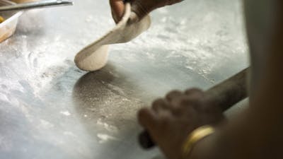 Chef rolling out dough