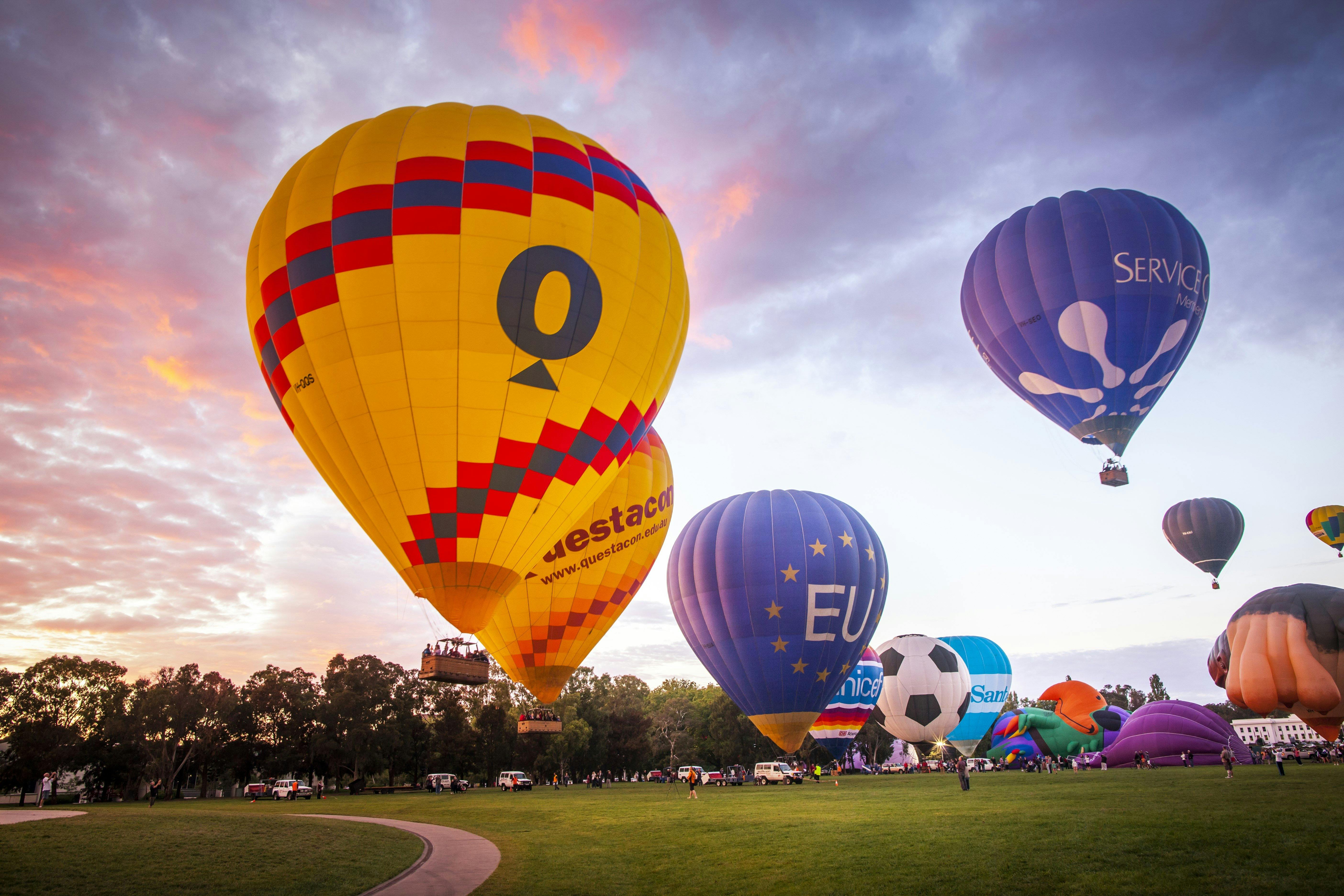 Balloons rising into the sky as dawn breaks