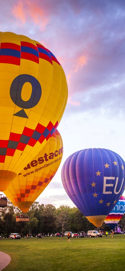 Balloons rising into the sky as dawn breaks