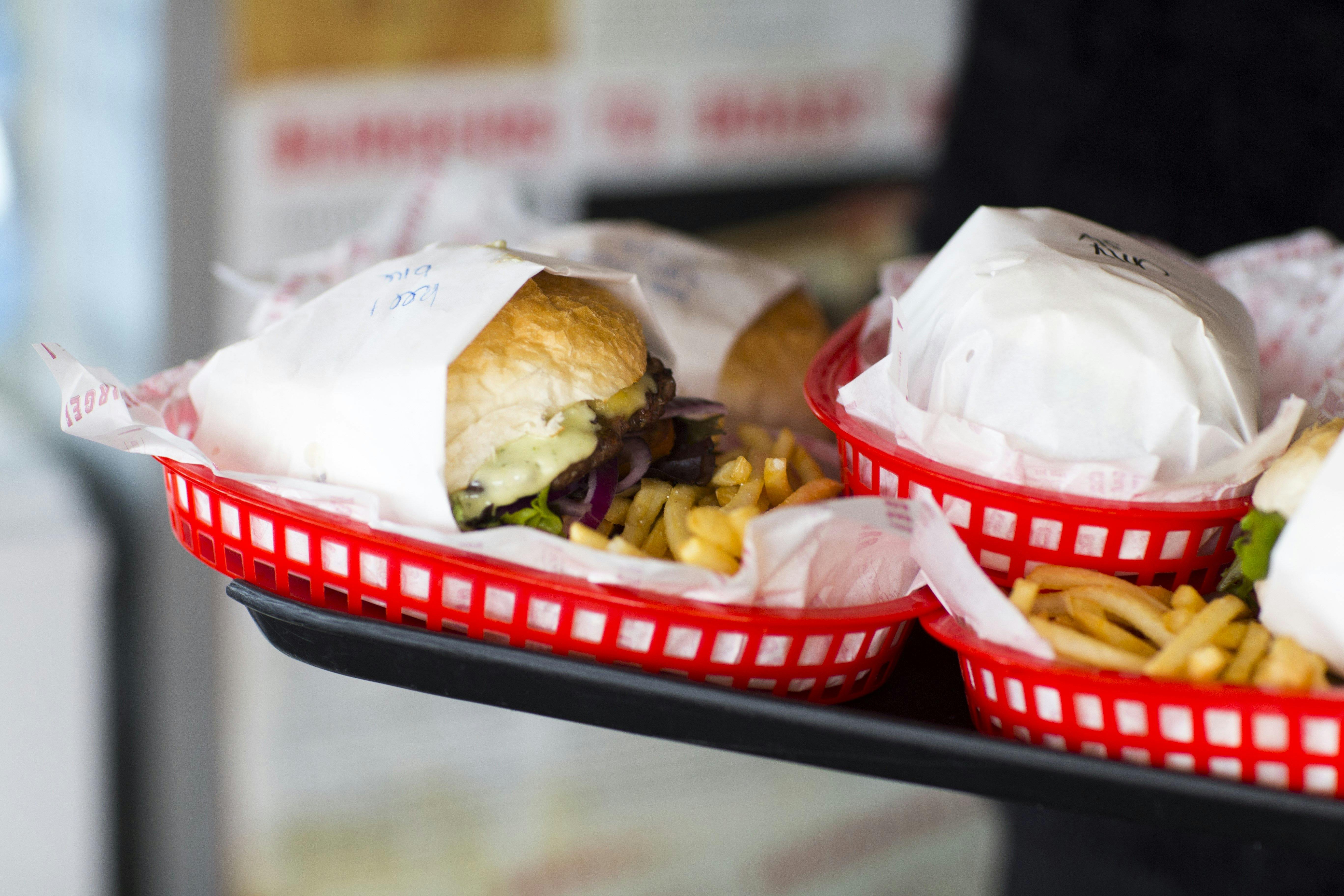Plates of burgers and fries on a tray