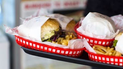 Plates of burgers and fries on a tray