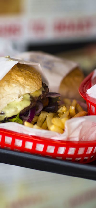 Plates of burgers and fries on a tray