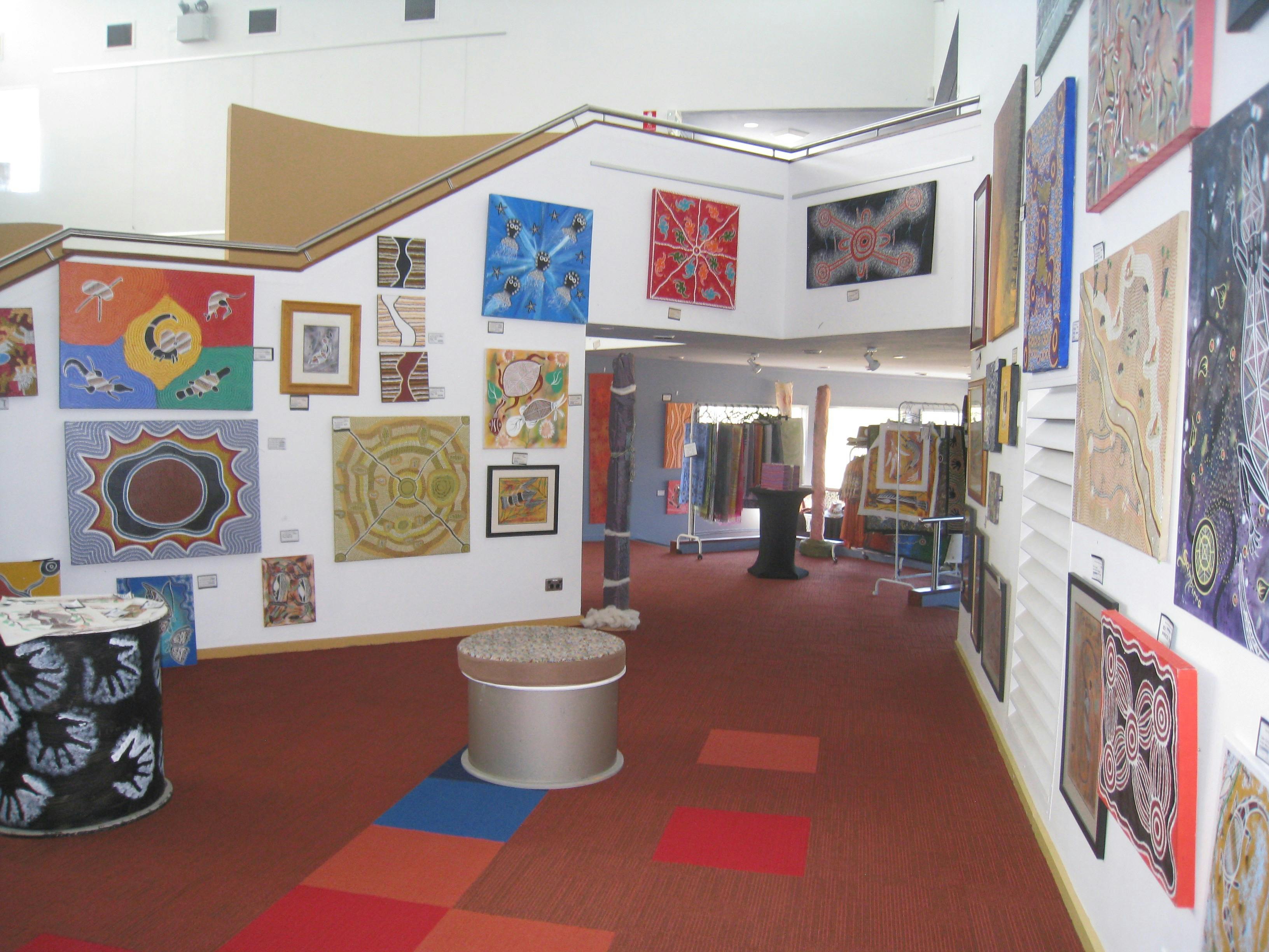 Artwork on display on the walls to the right of the staircase