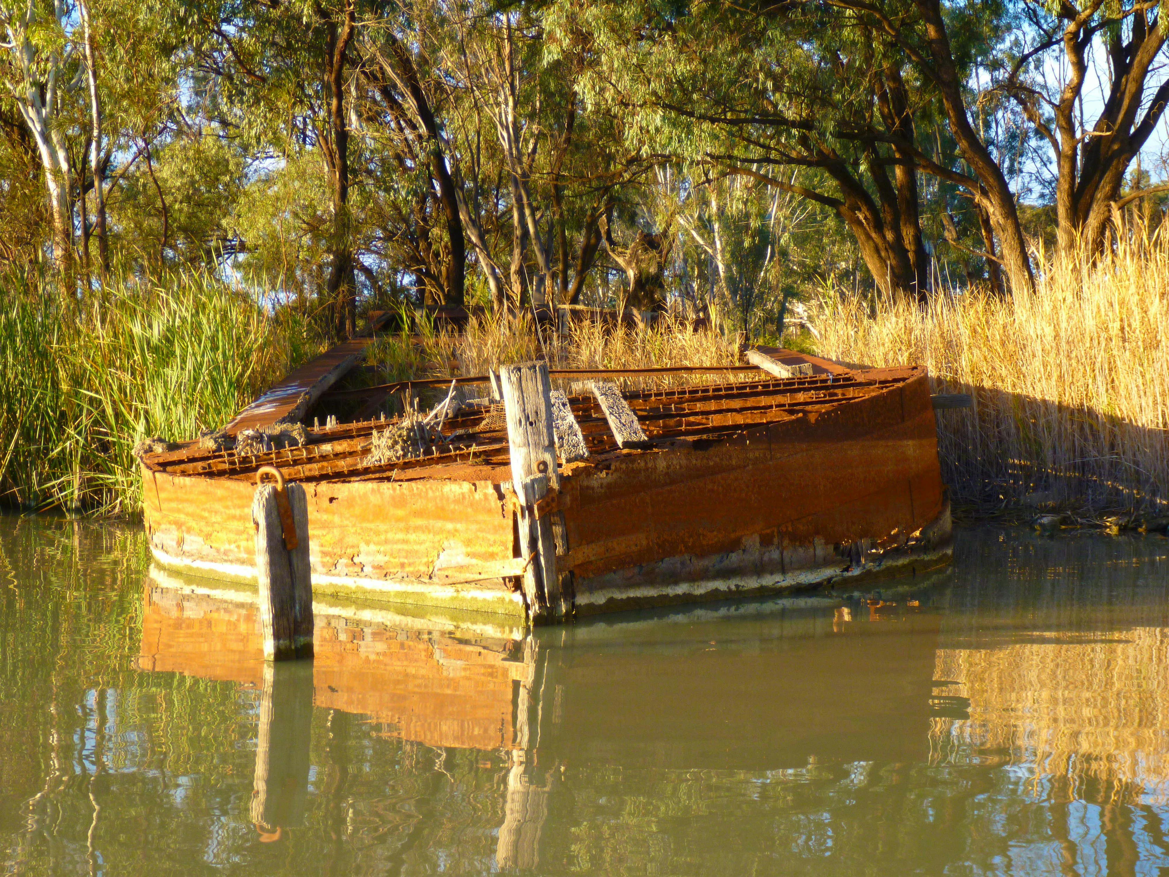Wrecked barge on creek bank
