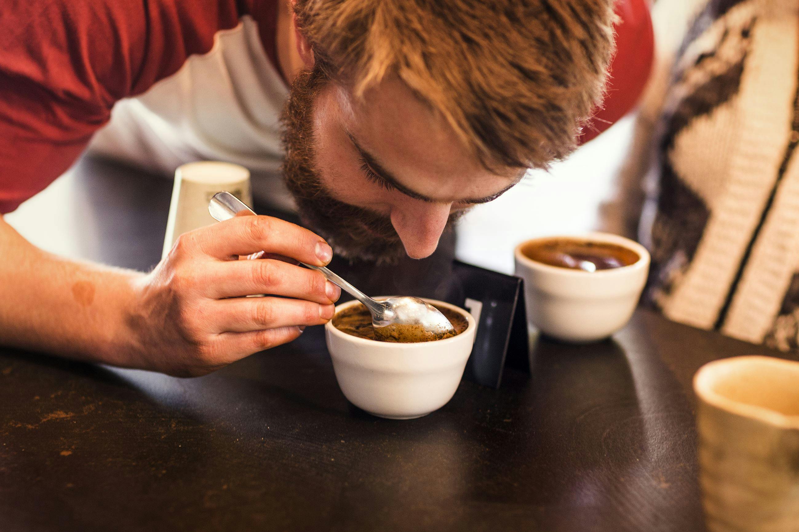 Man inhaling the coffee aroma in his cup