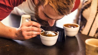 Man inhaling the coffee aroma in his cup