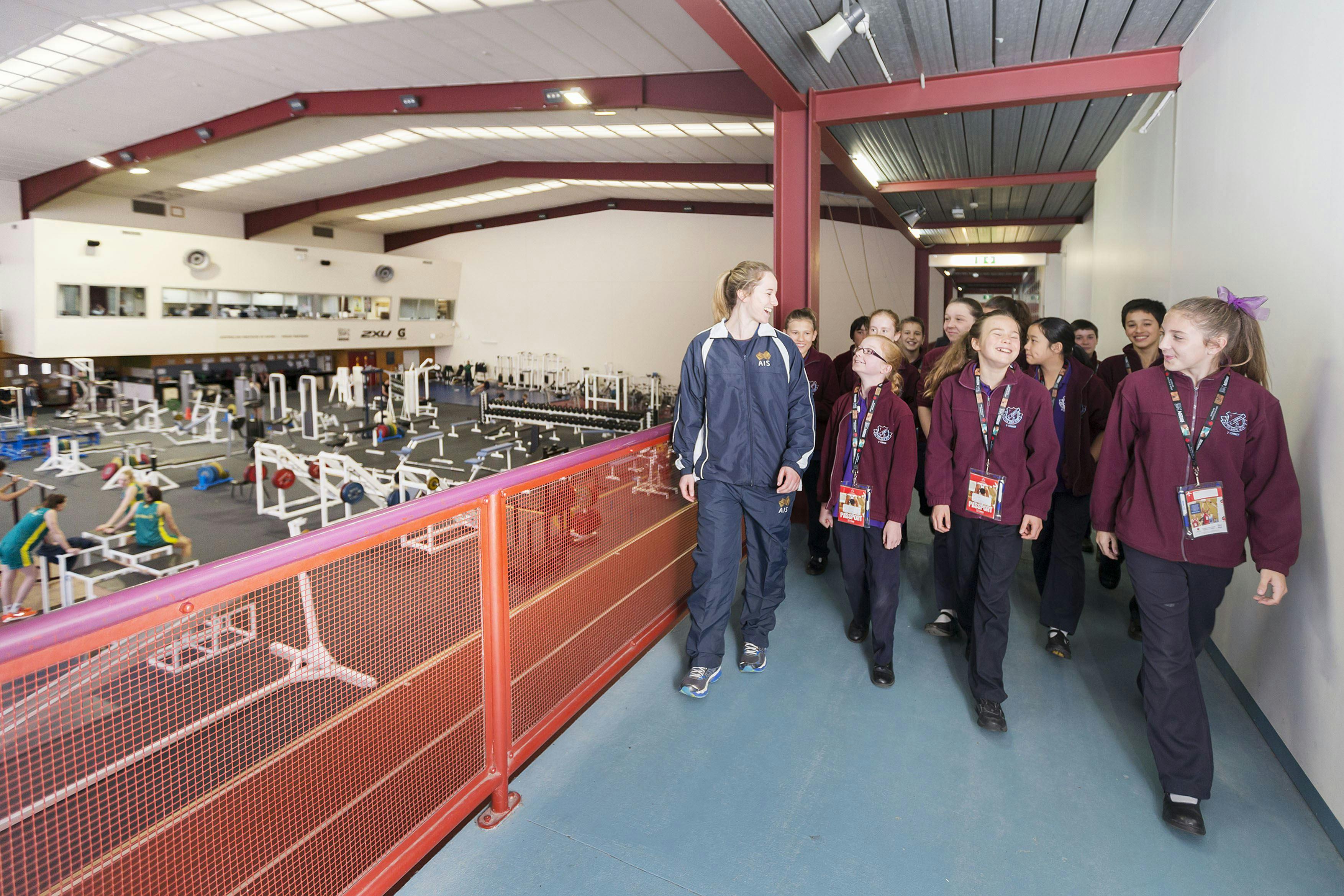 Tour group walking past the athletes training area