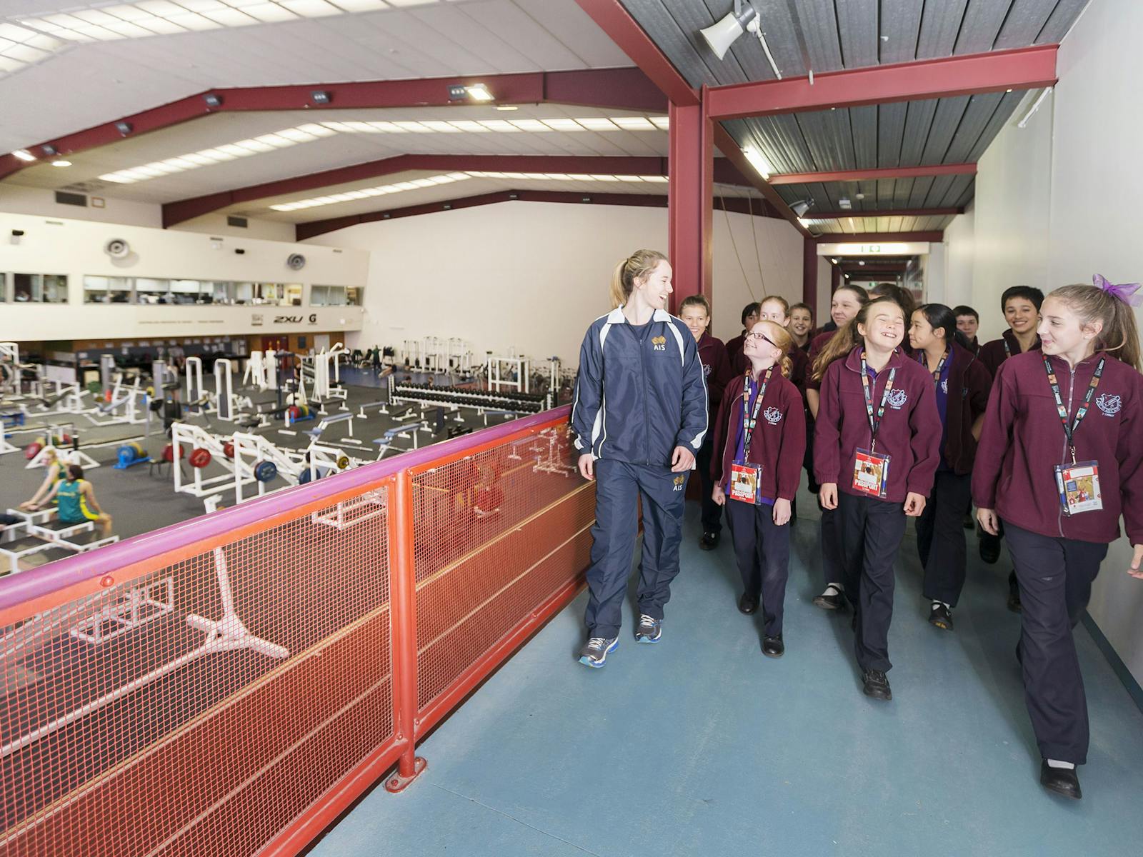 Tour group walking past the athletes training area