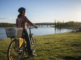 Girl on a Share A Bike bike at the lake