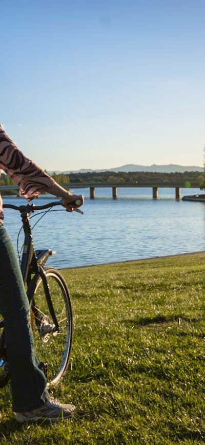 Girl on a Share A Bike bike at the lake