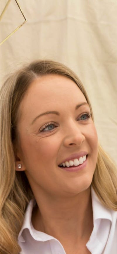 A visitor holding a hanging air plant at the Old Bus Depot Markets
