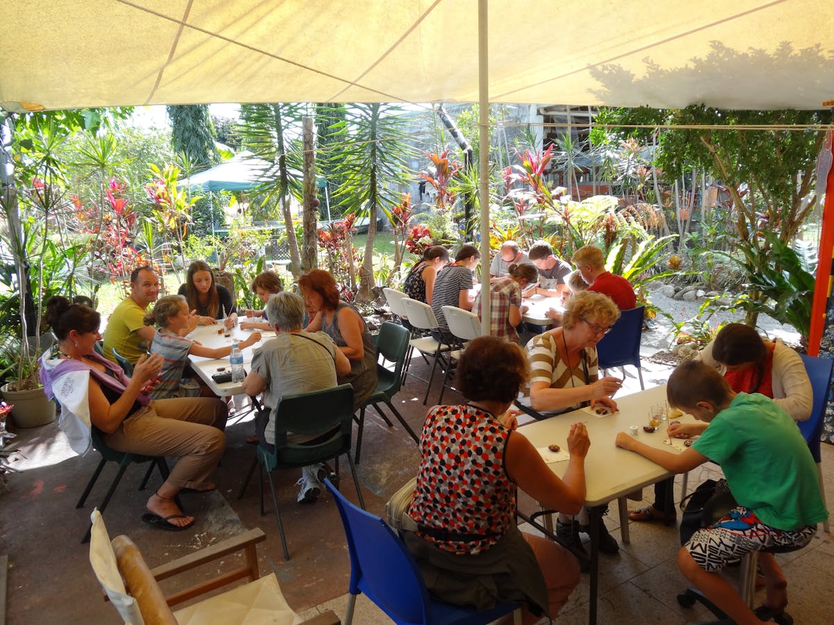 A large group enjoying Aboriginal Art Workshop at Janbal Gallery