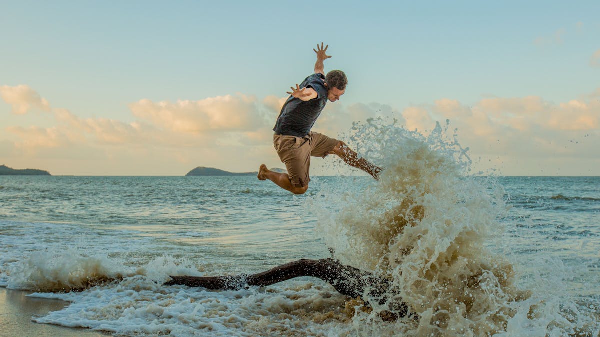 Jumping in the waves on Kewarra Beach