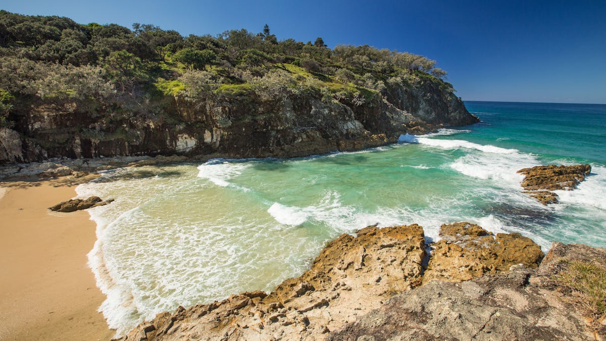 Sunny day for swimming at South Gorge, North Stradbroke Island, with vibrant blue-green waters