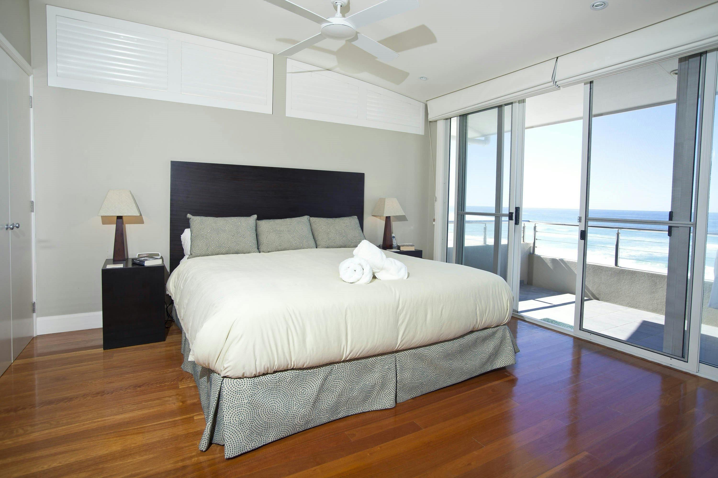 Azure's large master bedroom and private balcony overlook the beach.