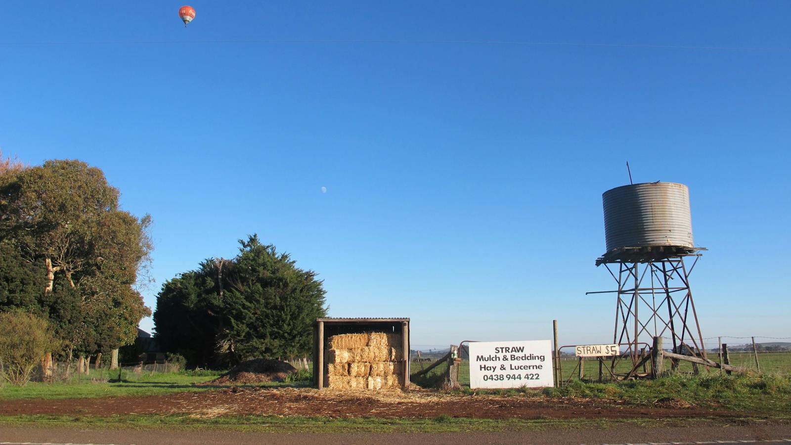 Hot air balloon through farm equipment at Daylesford