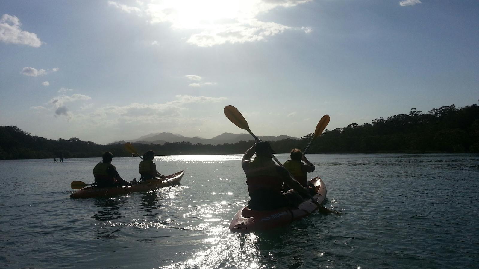 Kayak Cruising at Sunset with Great dividing range in background with C-Change Adventures