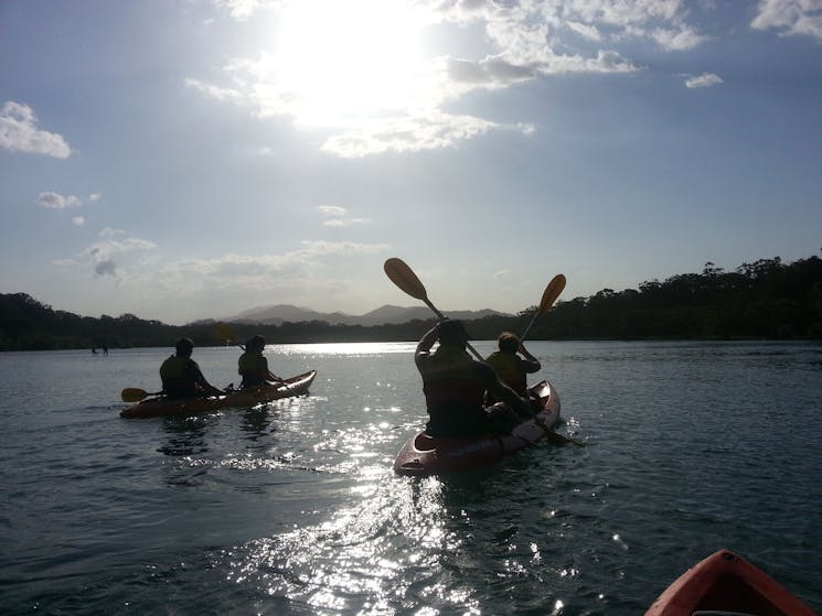 Kayak Cruising at Sunset with Great dividing range in background with C-Change Adventures