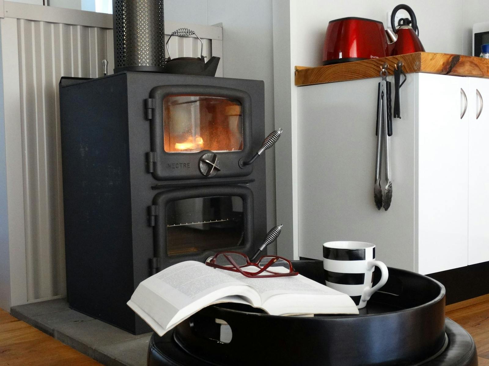 Fabulous compact wood stove for warmth & cooking; electric frypan, microwave etc also availablel