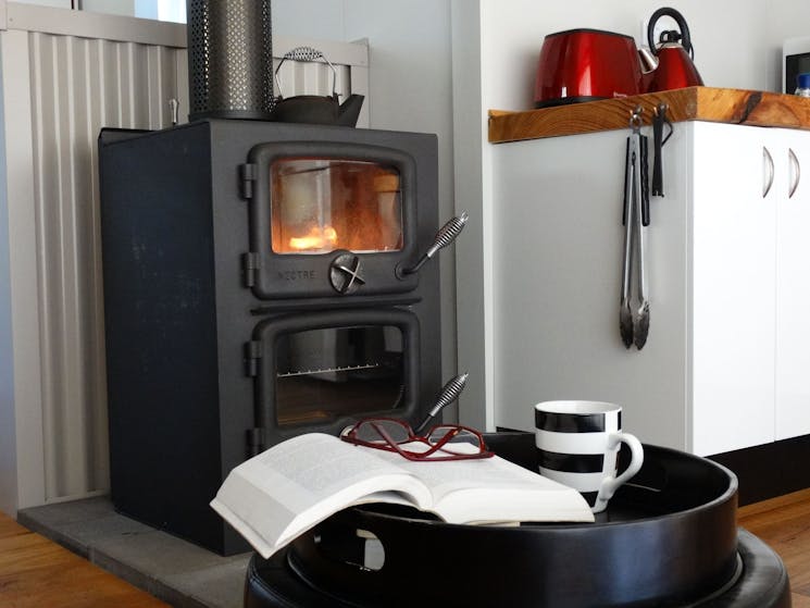 Fabulous compact wood stove for warmth & cooking; electric frypan, microwave etc also availablel