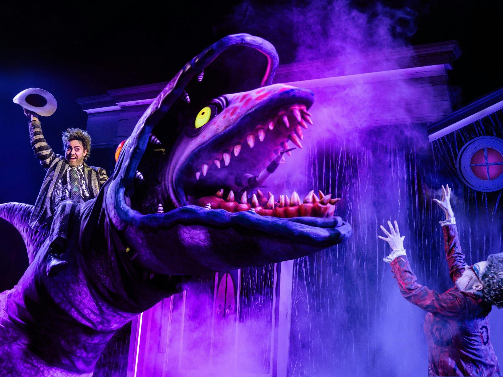 A demon ghost rides a giant sandworm monster.