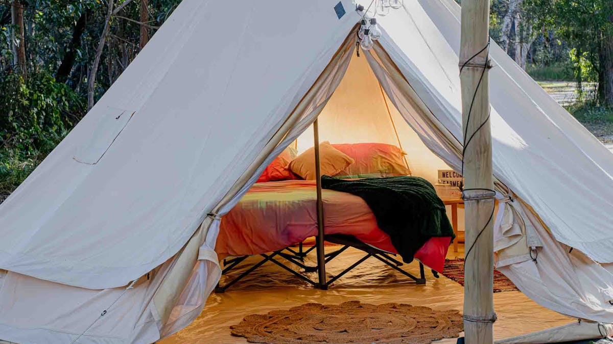 Glamping Bell Tent showing  a comfortable double mattress on a stretcher