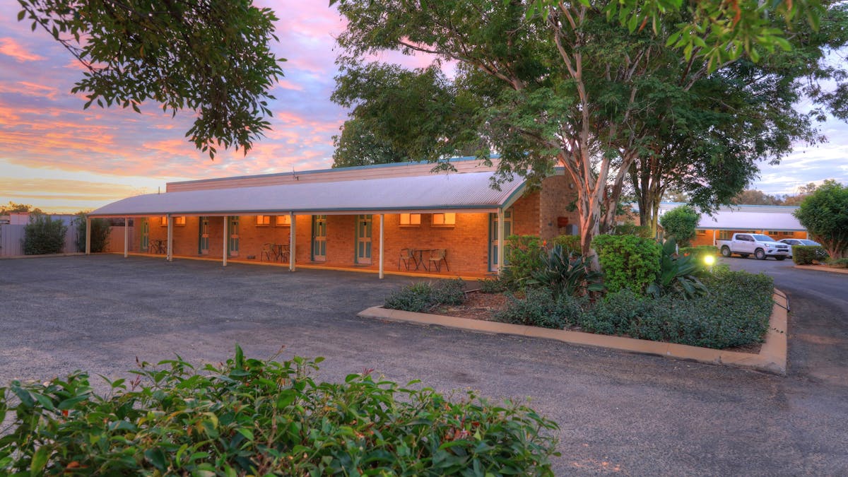 Photo of outside rooms with gardens and trees surrounding