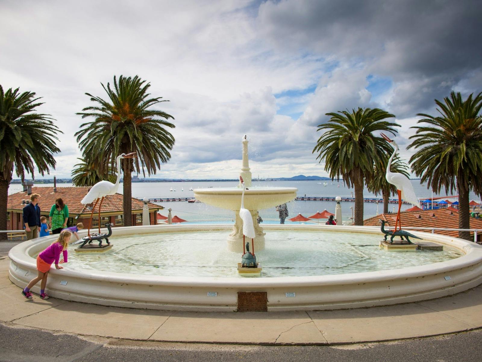 Water fountain with kids checking temperature of water