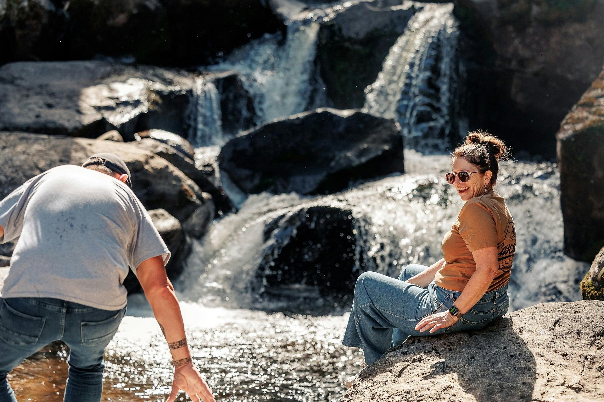 Man and woman sitting on  rocks at Keppel Falls
